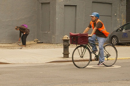 Mann auf Fahrrad fährt Paket aus
